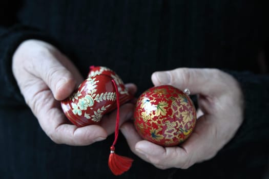 man holds old holiday ornaments
