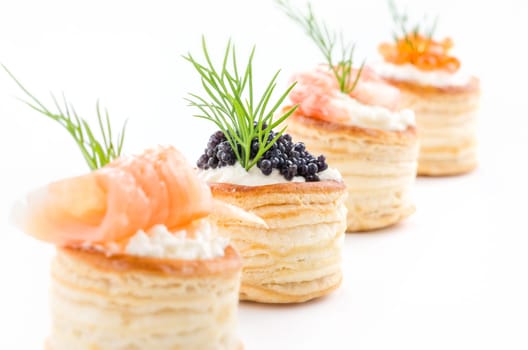 Puff pastry pies with salmon,caviar and prawns