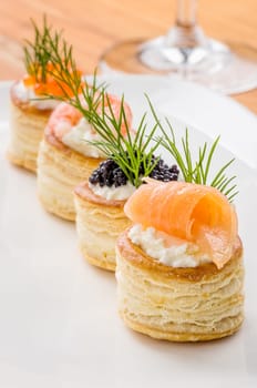 Puff pastry pies with salmon,caviar and prawns