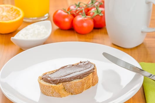 Baguette with hazelnut cream on a set breakfast table