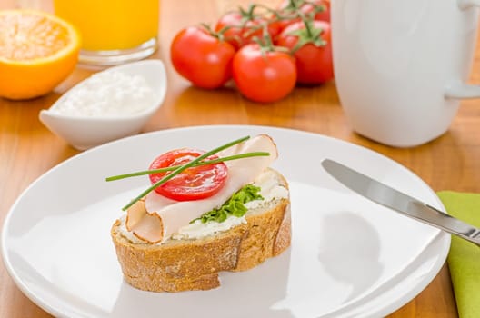 Baguette with turkey breast on a set breakfast table