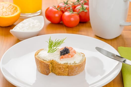 Baguette with shrimp and caviar on a set breakfast table