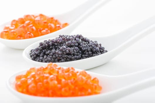 Red and black caviar on porcelain spoons
