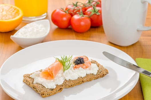 Crispbread with salmon and shrimp on a laid breakfast table