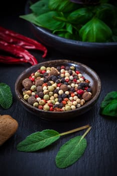 Herbs and spices on black background