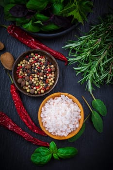 Herbs and spices on black background