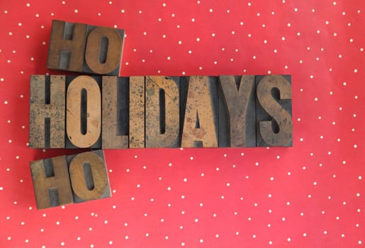 holidays ho ho words in old wood type on a polka dot background