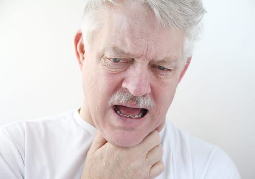 senior with a hand on his painful throat