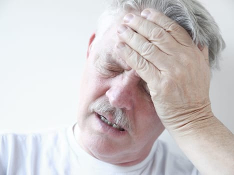 senior with hand on forehead and frown
