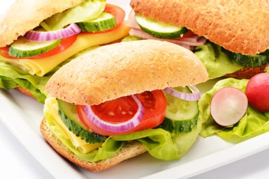 Composition with three sandwiches on white plate