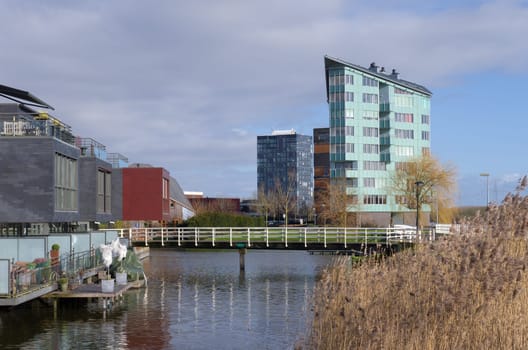 modern apartments and houses along a canal in Almere, netherlands