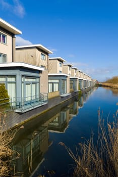 modern residential houses along a canal in almere, netherlands