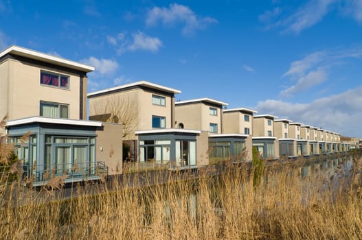 modern residential houses along a canal in almere, netherlands