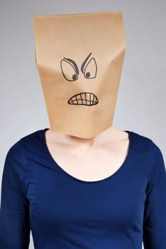 a mad looking person with paper bag head on a gray background