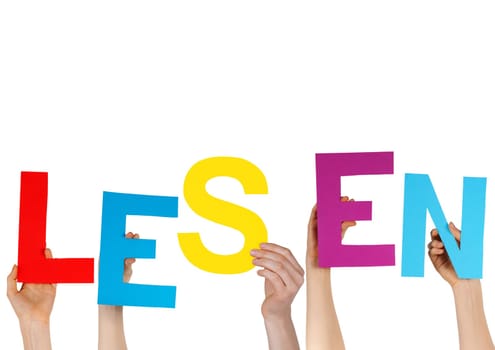 the german word LESEN in charakters hold by hands, isolated