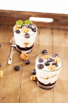Blueberries yogurt desserts on wood with blueberries