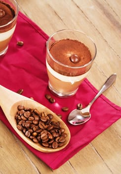 Tiramisu coffee dessert from above on wood with coffee beans