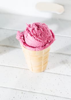 A blueberry ice cream from above on white wood