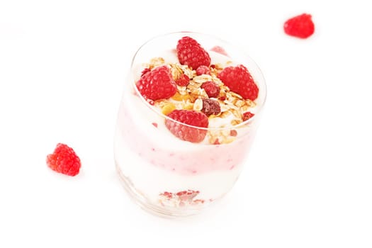 Muesli with raspberries in glass on white background