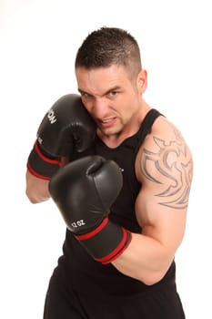 Boxer in sports dress,who seems to make an uppercut in front of the camera
