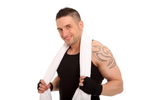 Portrait photo of a personal trainer looking into the camera with a friendly smile. He has put on a towel