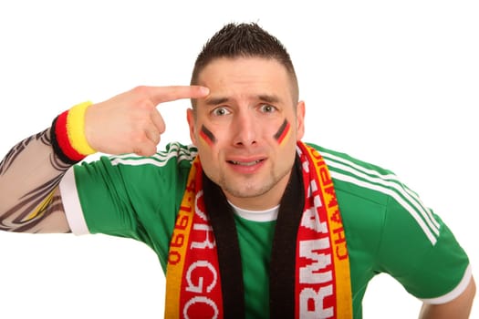 A football fan of the national team looks directly into the camera and shows a bird. He looks desperate.