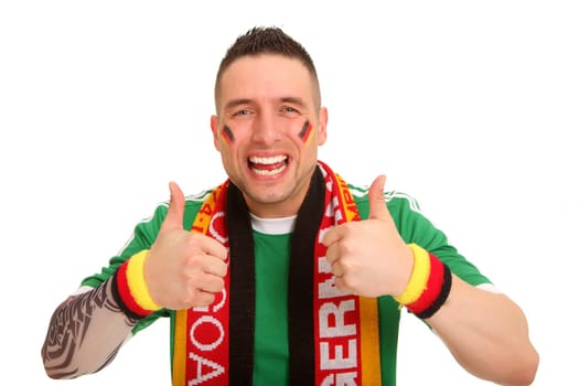 A football fan shows both thumbs up to the camera and seems very happy