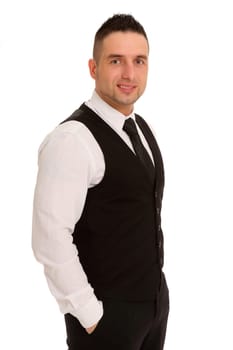 The photo shows a businessman standing,smiling into the camera and with his hands in his trouser pockets.