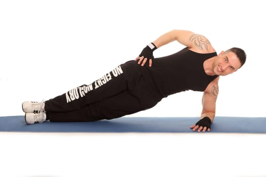 The photo shows a personal trainer lying on his side and exercising his muscles accordingly.