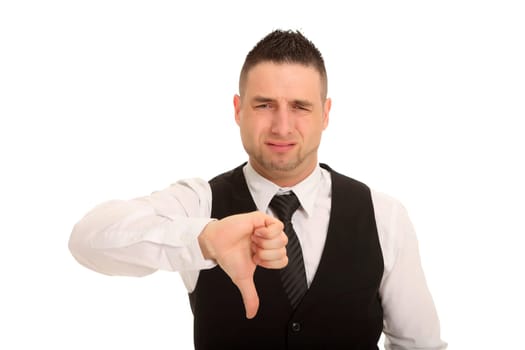 A young man points his thumb down and forgives his face in disappointment.