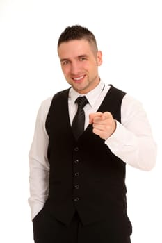 A businessman stands casually with one hand in his trouser pocket and points directly towards the camera.
