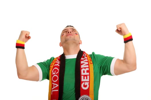 A football fan throws his arms up and cheers with his mouth closed.