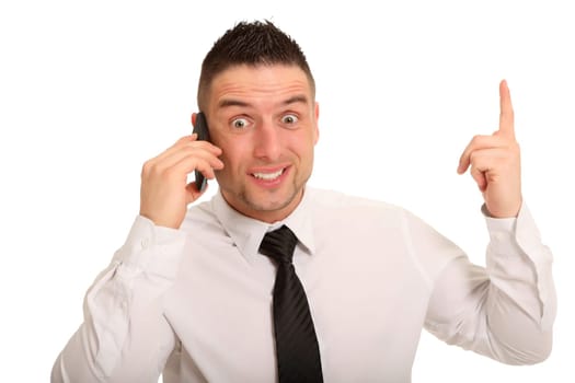 A young businessman is talking on the phone and seems to threaten or warn with his index finger