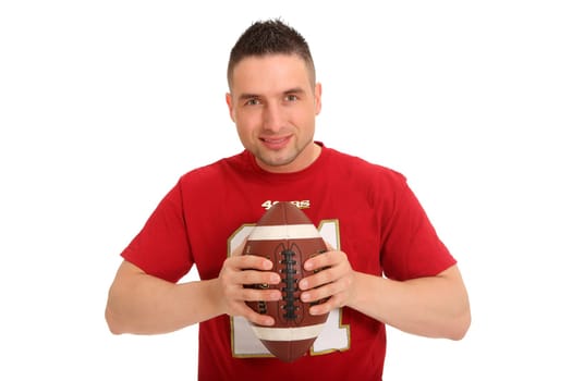 Portrait photo of a young man holding a football and smiling kindly at the camera