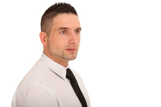 Portrait photo of a young businessman taken from the side. He looks into the distance.