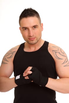 The photo shows an athletic,muscular type of man standing there with his hands folded.