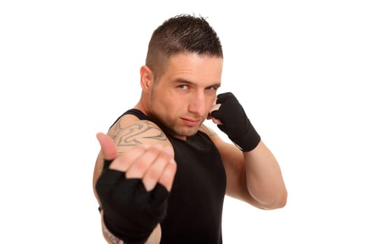 A young athlete stands there with gloves and seems to want to wave the viewer over