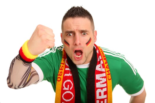 Portrait photo of a young man dressed as a fan. He has clenched his fist angrily and seems to be roaring downwards.