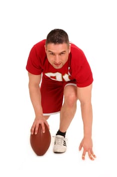 The photo shows a young man standing a football on the ground at the bottom and looking forward