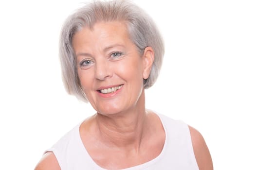 Smiling senior woman in front of white background