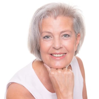 Smiling senior woman in front of white background