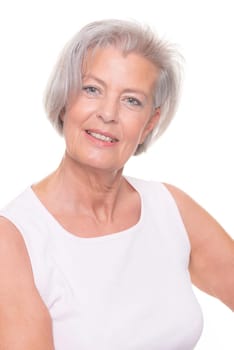 Smiling senior woman in front of white background