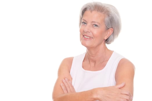 Smiling senior woman in front of white background