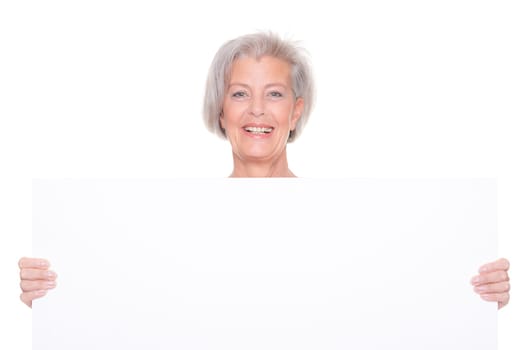 Senior woman holding billboard against white background