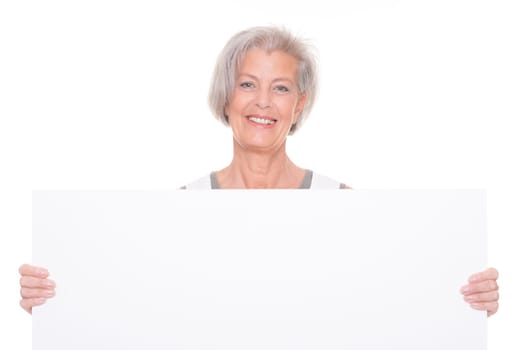 Senior woman holding billboard against white background