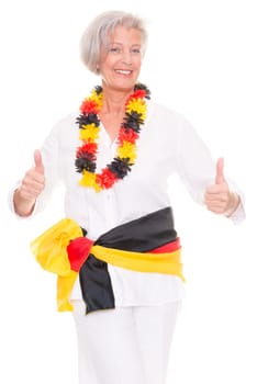 Senior woman as a German football fan in front of white background