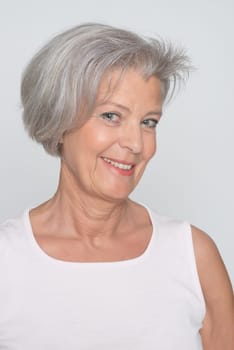 Middle-aged woman in front of gray background