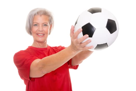 Active senior woman with a soccer ball