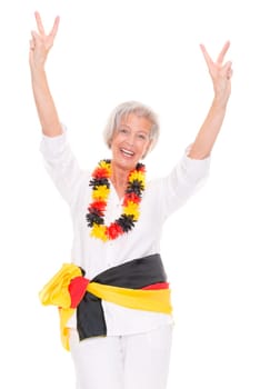 Senior woman as a German football fan in front of white background