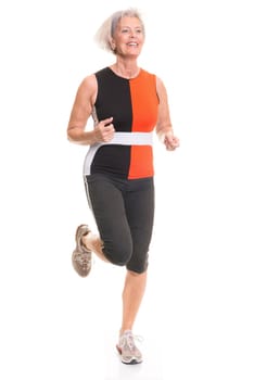 Senior woman doing sports in front of white background